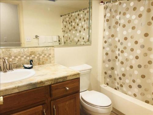 a bathroom with a toilet and a sink and a shower at Suntide I Condos W102 in South Padre Island