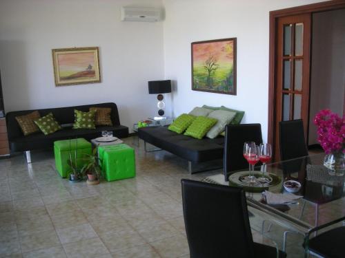 a living room with couches and a table with wine glasses at Villa On The Beach "Spiaggia Plaia" in Castellammare del Golfo