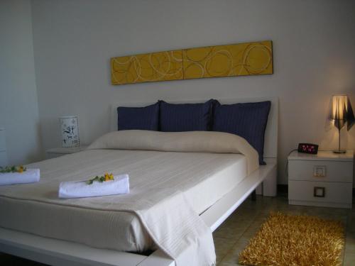 a bedroom with a bed with two towels on it at Villa On The Beach "Spiaggia Plaia" in Castellammare del Golfo