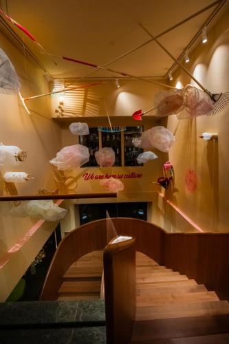a staircase in a restaurant with plastic bags on the wall at OMAMA Hotel in Aosta
