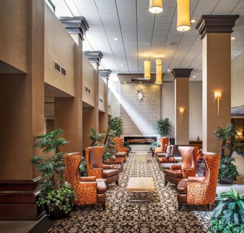 a lobby of a hospital with chairs and plants at Crowne Plaza Phoenix Airport, an IHG Hotel in Phoenix