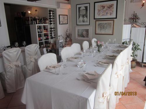 a white table with white chairs and a white table cloth at Locanda Della Fiorina in San Felice sul Panaro