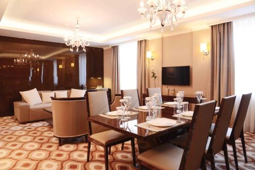 a dining room with a table and chairs at LOTTE City Hotels Tashkent Palace in Tashkent