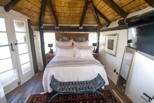 a bedroom with a bed in a room with windows at The Place Guesthouse Parys in Parys