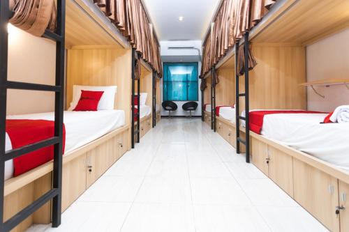 a row of bunk beds in a dorm room at RedDoorz Hostel @ Malang City Center 2 in Malang