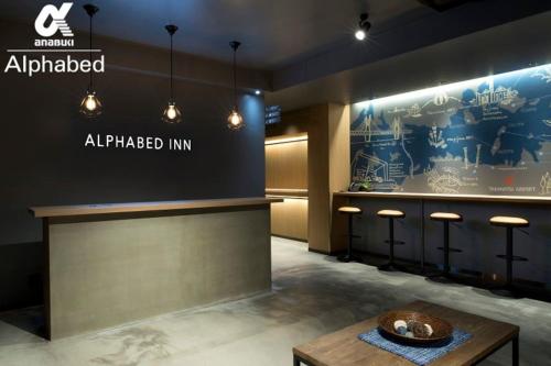 a lobby of an all fired inn with a table at ALPHABED INN Takamatsuekimae in Takamatsu