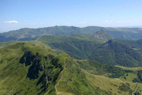 an aerial view of a green mountain range at Joli appartement à Murat proche du Lioran Cantal in Murat