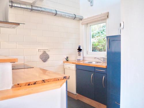 a kitchen with a blue refrigerator and a sink at Studio bij Zee in Ouddorp