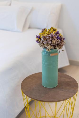 a blue vase with flowers sitting on a table at Viles Can Moreno in Ses Salines