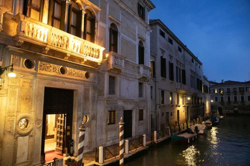 a view of a canal in a city at night at Ca' Vendramin Zago in Venice