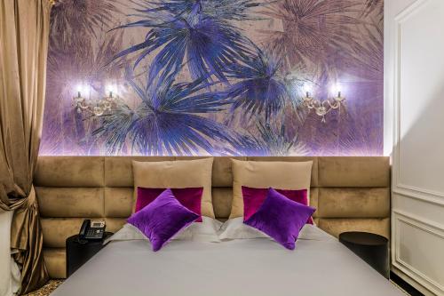 a bedroom with a bed with purple and purple walls at Ca' Pagan in Venice