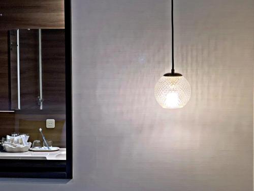 a light fixture hanging from a wall in a kitchen at the b akasaka-mitsuke in Tokyo