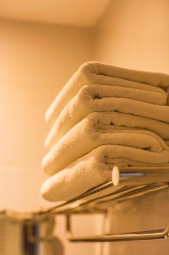 a stack of towels on top of a drying rack at Pro Andaman Place in Karon Beach