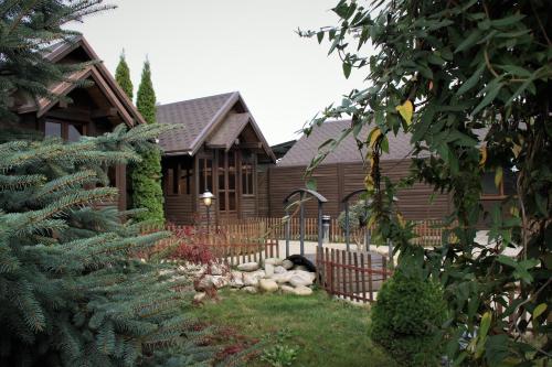 a house with a fence in front of a yard at Kamelot in Ternopilʼ