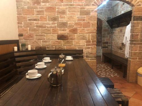 a wooden table in a room with a brick wall at Kamelot in Ternopilʼ