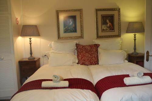 a bedroom with a bed with two towels on it at Le Residence de Josephine in Kloof
