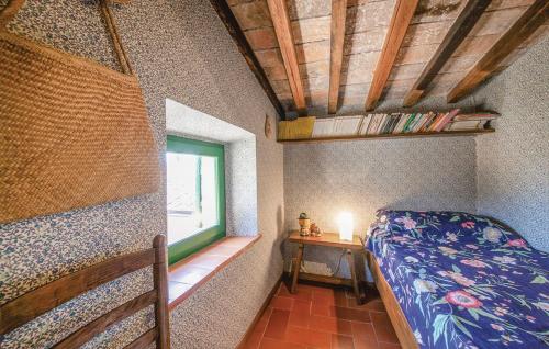 a small bedroom with a bed and a window at La Ginestra - Terrazza in Orciatico