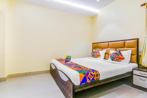 a bedroom with a large bed in a room at FabHotel Aayash in Kolkata
