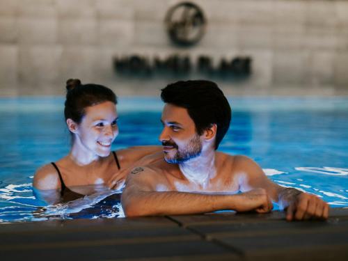 a man and a woman in a swimming pool at Empire Apart OVO in Wrocław