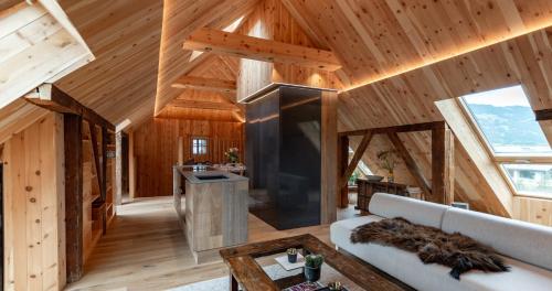 a large living room with wooden walls and ceilings at das Stieger in Maishofen