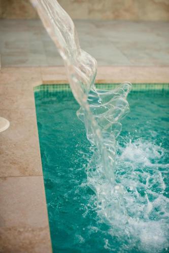 a splash of water in a swimming pool at El Patio de los Jazmines Boutique-House in Consuegra