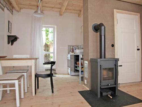 a living room with a stove and a table at Töpferhof 1 in Tangermünde