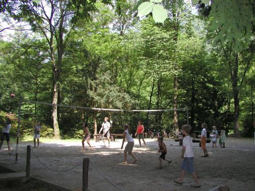 a group of people playing volleyball in a park at Camping & Resort Valle Romantica in Cannobio