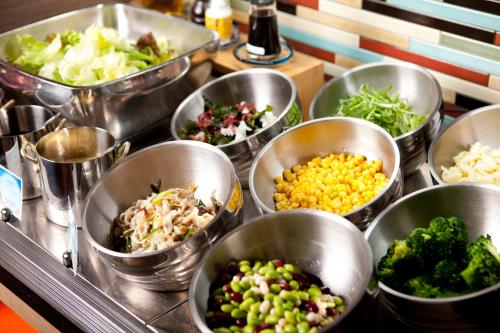 a bunch of bowls filled with different types of vegetables at Almont Hotel Naha Kenchomae in Naha