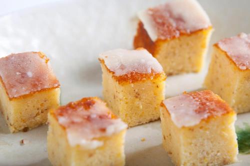 a pile of cake bites with powdered sugar on top at Almont Hotel Naha Kenchomae in Naha