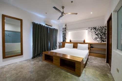 a bedroom with a bed and a large window at Capital O 468 Element Boutique Hotel in Manila