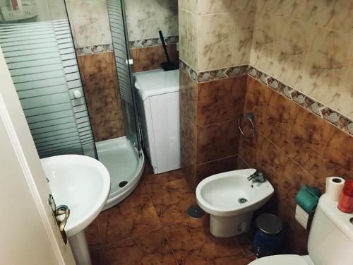 a bathroom with a sink and a toilet and a shower at Apartment on Playa Las Vistas in Arona