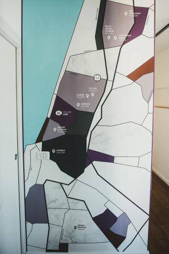 a wall mural in a room with a map at The Rambam Residence - By Localz Group in Tel Aviv