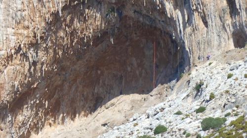 a rocky mountain with people standing in the middle at Oasis Hotel in Masouri
