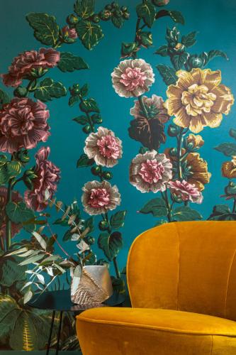 a wall with a floral mural of flowers on a wall at Maison Dauphine in Aix-en-Provence