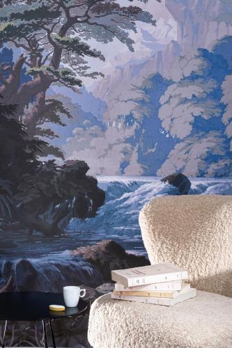a painting of a river with books on a chair at Maison Dauphine in Aix-en-Provence