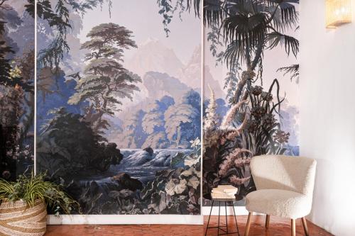 a room with a large wall mural of a waterfall at Maison Dauphine in Aix-en-Provence