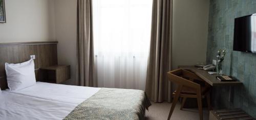 Ένα ή περισσότερα κρεβάτια σε δωμάτιο στο Fidelitas Hotel