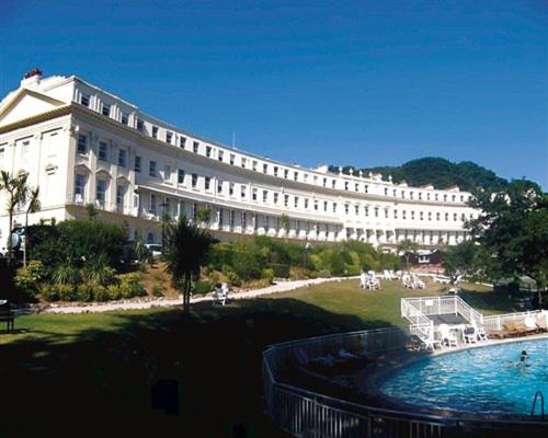 a large white building with a pool in front of it at **Sunny and Bright, Thatchers Rock One bed beach front apartment*** in Torquay