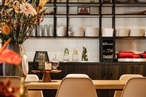 a dining room with a table and chairs and a counter at The Delphi - Amsterdam Townhouse in Amsterdam