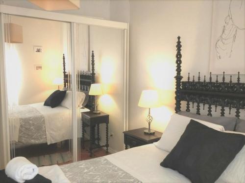 um quarto com uma cama e um espelho grande em Sabrosa's Flat em Lisboa