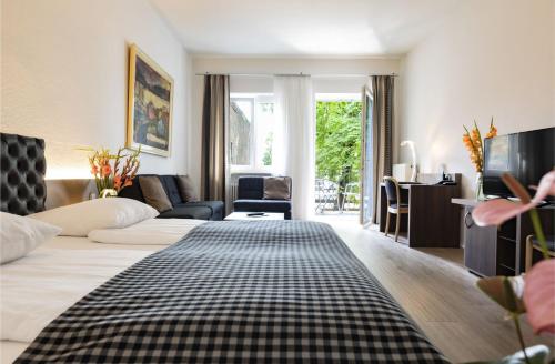 a hotel room with a bed and a living room at Dom Hotel in Augsburg