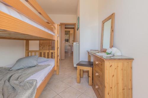 a bedroom with two bunk beds and a mirror at Palma Romantic Dream in Perledo