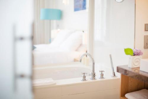 a bathroom with a sink and a bath tub at Sun Gardens Dubrovnik in Dubrovnik