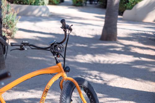 an orange bike parked on a street at DS One Vacances, Prairies de la Mer in Grimaud