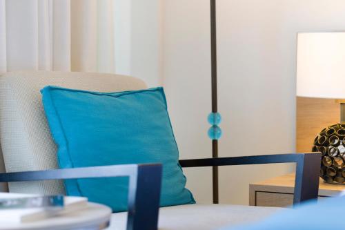 a blue pillow sitting on a chair in a room at Sun Gardens Dubrovnik in Dubrovnik