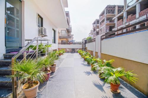 a walkway with potted plants on a building at FabHotel Gazelle Studios in Gurgaon