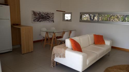 uma sala de estar com um sofá branco e uma mesa em Freyre 754 - Departamentos temporarios categoría em Rosário