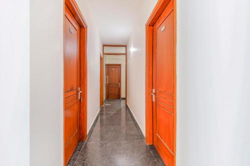 a hallway with two wooden doors and a hallway with a hallway at FabHotel Gazelle Studios in Gurgaon