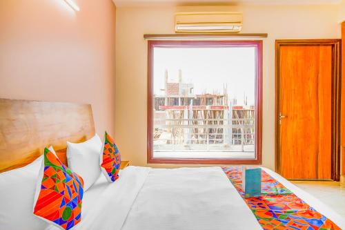 a bedroom with a bed and a window at FabHotel Gazelle Studios in Gurgaon