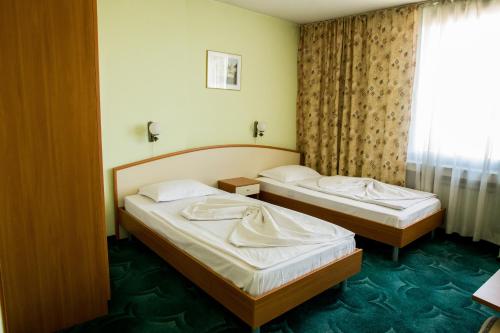 Postel nebo postele na pokoji v ubytování Struma Hotel